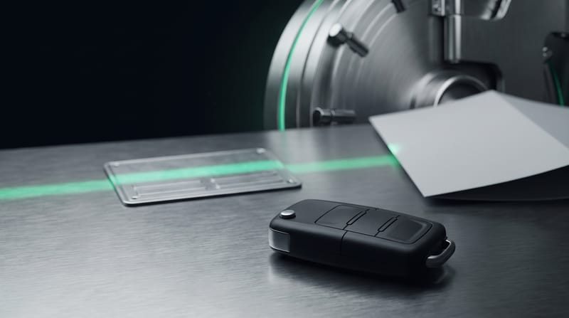 A car key, a blank number plate and a document on a steel counter, crossed by an emerald scan line